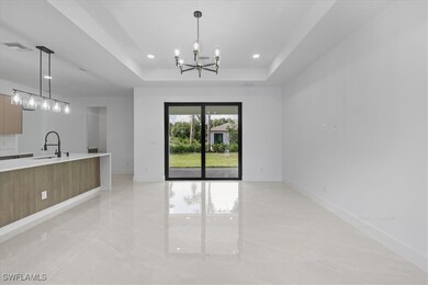 Kitchen featuring modern cabinets, a chandelier, l