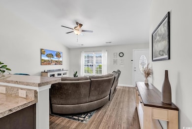 Living area featuring lofted ceiling, wood finishe