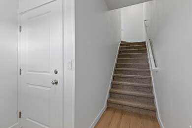Staircase featuring baseboards and wood finished floors