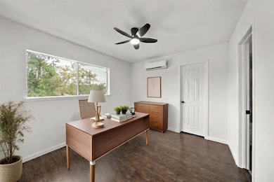 Secondary bedroom virtually staged as an office.