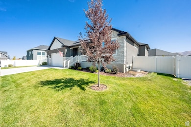 View of front of home with concrete driveway, an attached garage, and solar panels
