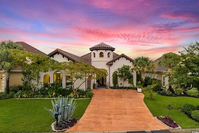 Mediterranean / spanish home featuring a yard, concrete driveway, and stucco siding