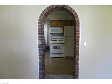 Lovely brick archway from Family Room to Kitchen