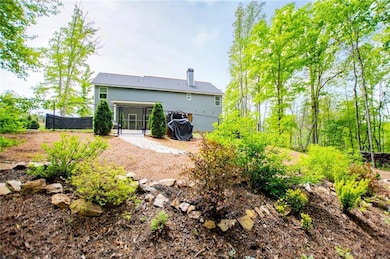 Rear view of house featuring fence, a gate, and a 