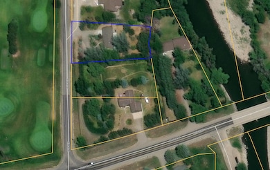 Aerial map close up of property with Cottonwood Hills Golf Course located across the street to the West and Gallatin River around the corner to the East. The property boundaries are highlighted in blue.
