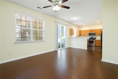 Unfurnished living room featuring ceiling fan, bas