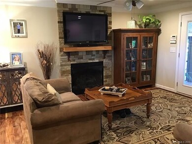 DEN WITH FIREPLACE OPENS TO KITCHEN AND SUNROOM (N