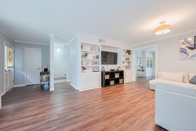 Spacious open living room with built in shelving a