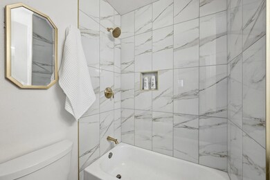 Bathroom with toilet and bathing tub / shower com