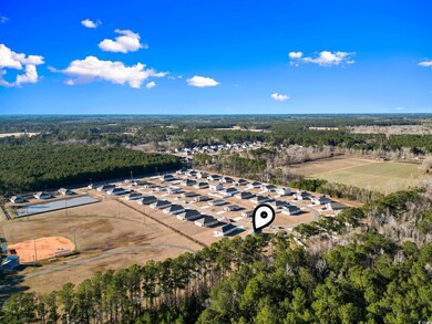 Birds eye view of property featuring a view of tre
