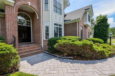 Stamped concrete walkway from driveway leads to fr