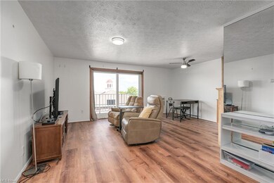Living room featuring a textured ceiling, light ha