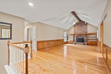 Great room with vaulted ceilings and a fireplace