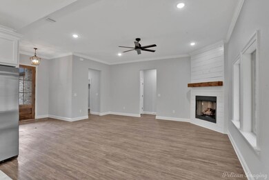 Unfurnished living room with ceiling fan with nota