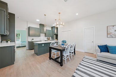 Dining area featuring light wood finished floors, recessed lighting, and a chandelier
