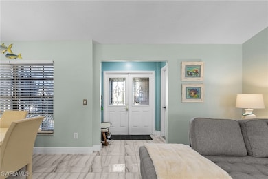 Entryway featuring marble finish floor, baseboards
