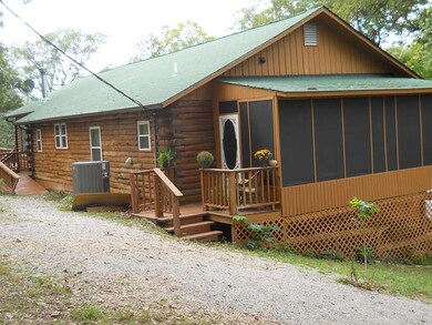 Exterior Front. Lovely long Morrell Log Home with breezy screened in porch on one end and enormous deck on the other