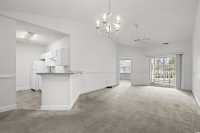 Unfurnished living room featuring light colored ca