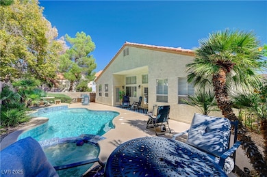 View of swimming pool featuring a pool with connected hot tub, a patio area, and outdoor dining space