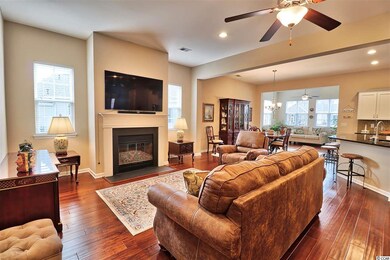 The Family Room features a gas fireplace and is open to the Kitchen and Dining Room.