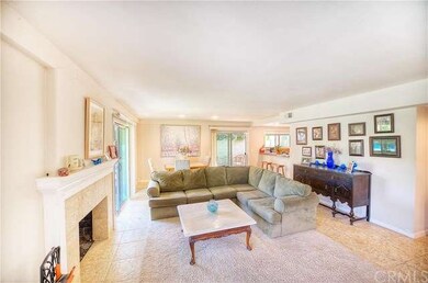 Looking across living room to dining area and out 