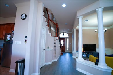 Entryway with decorative columns, dark wood-style