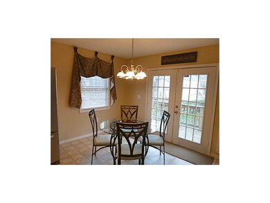 Sunny eating area has french doors leaving to deck