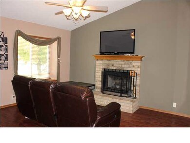 LIVING ROOM WITH VAULTED CEILING, FIREPLACE, AND W