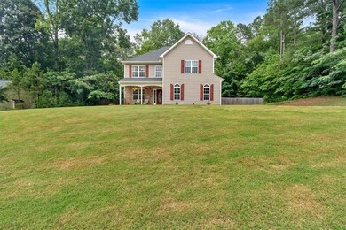 View of front of house with covered porch and front yard.
