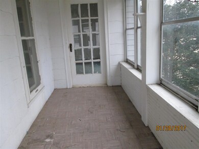 Front porch looking west.  Notice door that opens 