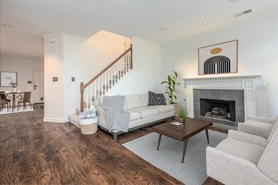 Living room featuring ornamental molding, dark har