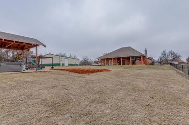 View of yard featuring a garage and a hot tub