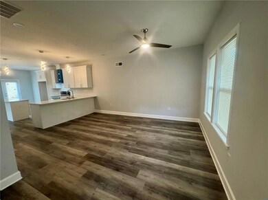 Unfurnished diningroom a ceiling fan, dark wood finished floors, and recessed lighting