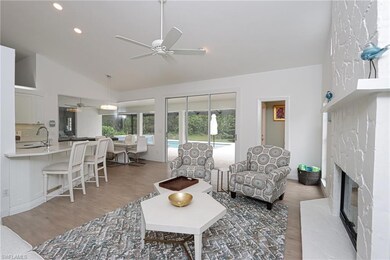 Living room featuring high vaulted ceiling, a fire