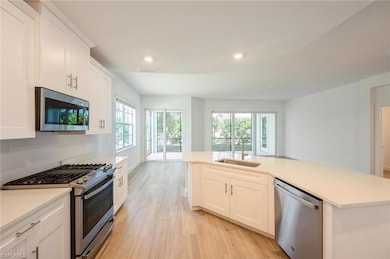 Kitchen featuring a sink, visible vents, appliance