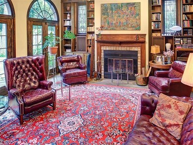 Family room boasts 12 ft ceilings, floor to ceilin