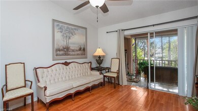 Living area featuring ceiling fan, vaulted ceiling