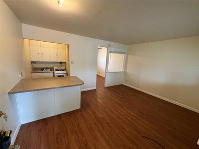 Kitchen with white range with gas stovetop, dark 