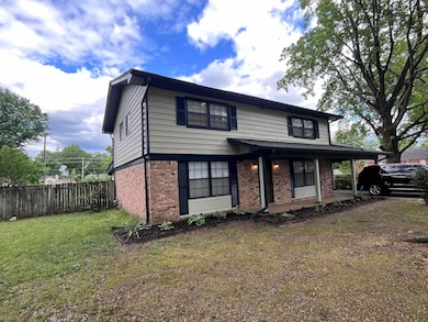 Traditional home with brick siding and covered por