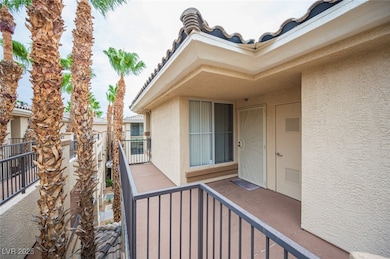 Property entrance with stucco siding and a tiled roof