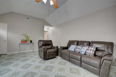Living room featuring ceiling fan and lofted ceili