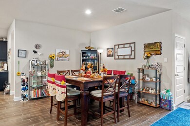 Dining room featuring wood finish floors and recessed lighting