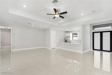Unfurnished living room featuring a tray ceiling,