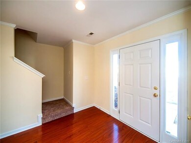 Spacious foyer with natural light features a conve
