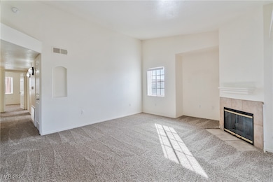 Unfurnished living room featuring carpet flooring and a fireplace