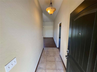 Hallway featuring light tile patterned floors and 