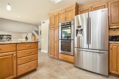 This fully updated kitchen features granite counters, stainless appliances, dual ovens, and a 5-burner gas cooktop