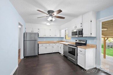 Bright kitchen with Butcher Block counters and lots of Light