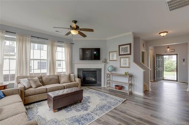 Large Family room with Natural gas fireplace. Carefree Luxury Plank Vinyl throughout downstairs