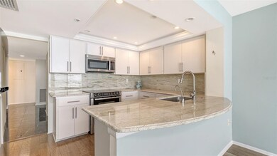 Updated kitchen offers stainless appliances and breakfast bar for a quick meal.
